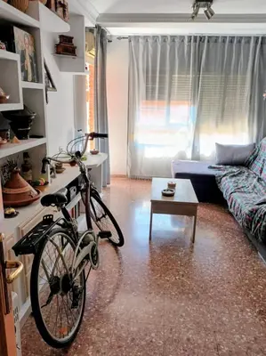 a bike parked in a living room with a couch at Alquilo habitación 24 euros por noche Super Top in Valencia