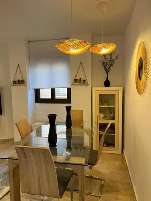 a dining room with a glass table and chairs at La Llum de Serra in Serra