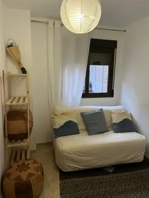 a living room with a white couch and a window at La Llum de Serra in Serra