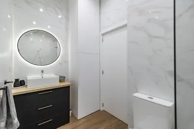 a bathroom with a sink and a mirror at Prime Location, Bright & Cozy Apartment in Valencia