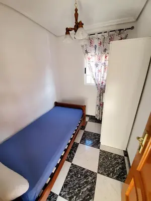 a bed in a room with a checkered floor at House Mare Nostrum in Moncófar