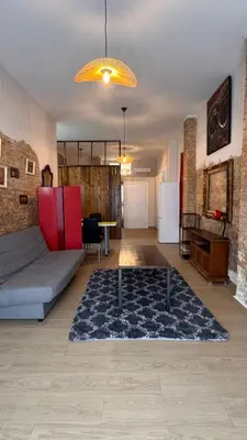 a living room with a couch and a rug at Gran Loft en planta baja en el Centro de Valencia in Valencia