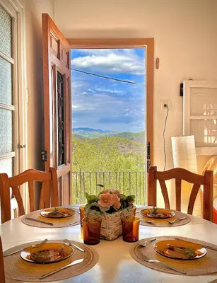 a table with two plates and a view of a window at El Cortijo a cielo abierto entre montañas in Estivella
