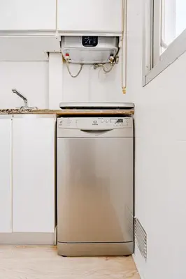 a kitchen with a dishwasher and a sink at The Cabanal Beach House - 10 min to ocean, FastWifi, AC, Coffee in Valencia