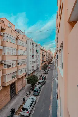 a city street with parked cars and buildings at The Cabanal Beach House - 10 min to ocean, FastWifi, AC, Coffee in Valencia
