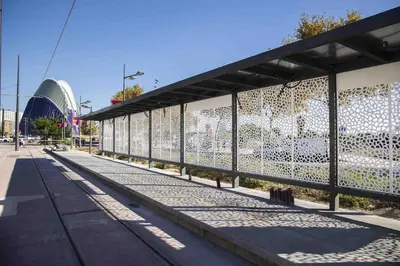 a building with a fence next to a street at Suite junto Ciudad de las Ciencias - Manolito 2 in Valencia