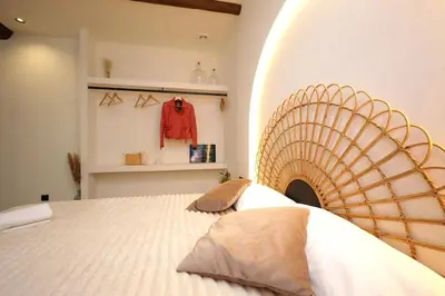 a bedroom with a large bed with a curved wall at Eco suite Puerto - Manolito 3 in Valencia