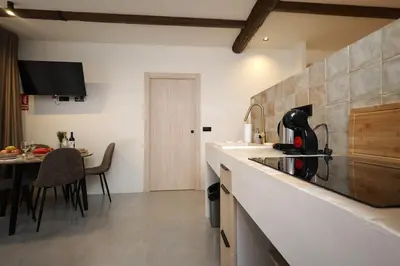 a kitchen with a counter top and a table at Eco suite Puerto - Manolito 3 in Valencia