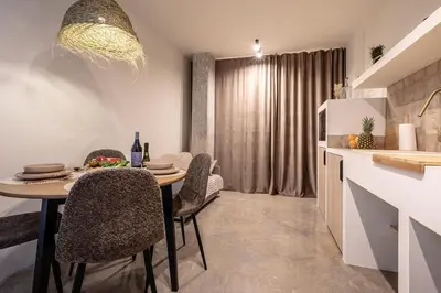 a kitchen and dining room with a table and chairs at Suite Ciudad de las Ciencias y Puerto - Manolito 4 in Valencia