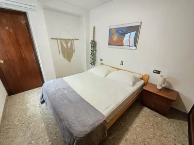 a bedroom with a bed and a wooden door at Simat Malina in Simat de Valldigna