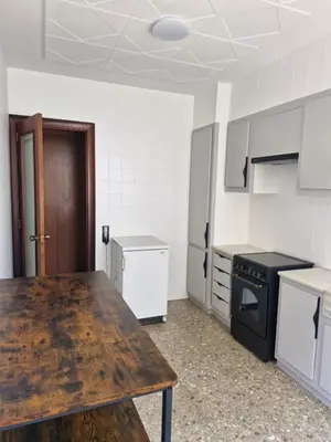 an empty kitchen with a wooden table in a room at Simat Malina in Simat de Valldigna