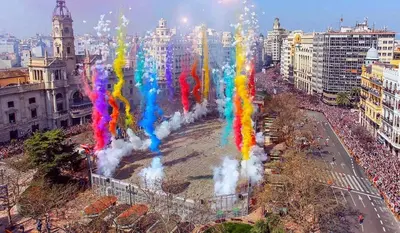 a large crowd of people in a city with colored smoke at Apartment near the beach and the City of Sciences in Valencia