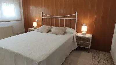 a bedroom with a large white bed with two night stands at Casa Principal Finca Mas el Bravo in Caudiel