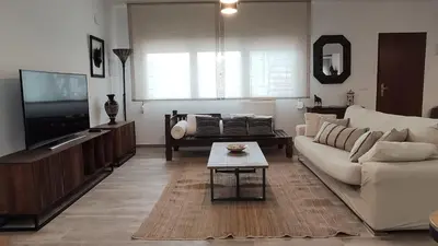 a living room with a couch and a tv at Casa Principal Finca Mas el Bravo in Caudiel