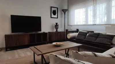 a living room with a couch and a television at Casa Principal Finca Mas el Bravo in Caudiel