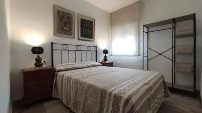 a bedroom with a large bed and a window at Casa Principal Finca Mas el Bravo in Caudiel