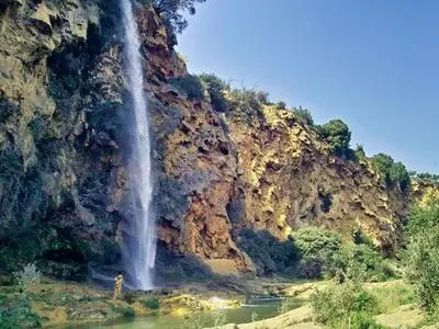 a person standing in front of a waterfall at Casa Principal Finca Mas el Bravo in Caudiel