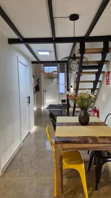 a dining room with a table and yellow chairs at Excepcional Amplio Apartamento Industrial Fallas hasta 6, wifi gratis cuna in Valencia