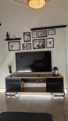 a large entertainment center with a large television in a living room at Excepcional Amplio Apartamento Industrial Fallas hasta 6, wifi gratis cuna in Valencia