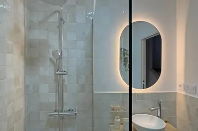 a bathroom with a shower with a sink and a mirror at Casa La Pedrera in Pedralba
