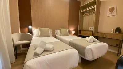 a bedroom with a bed with two towels on it at Marina Boutique in Valencia