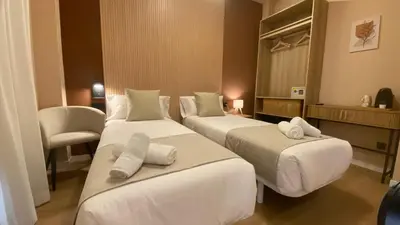 a bedroom with a bed with two towels on it at Marina Boutique in Valencia