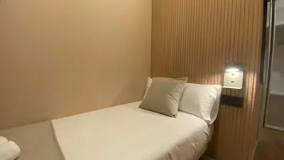 a bedroom with a bed with two towels on it at Marina Boutique in Valencia