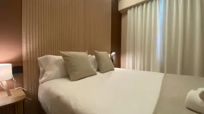 a bedroom with a white bed and a window at Marina Boutique in Valencia