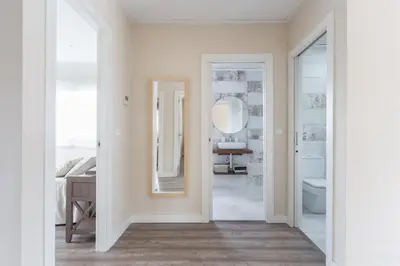 a hallway with a bathroom with a mirror and a sink at White House with MINIGOLF 10 minutes from Cullera in Corbera de Alcira