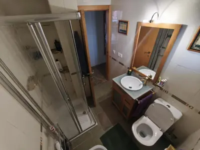 a bathroom with a shower and a toilet and a sink at Sientete como en casa in Sedaví
