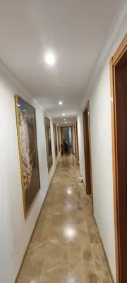 a hallway with paintings on the walls of a building at Sientete como en casa in Sedaví