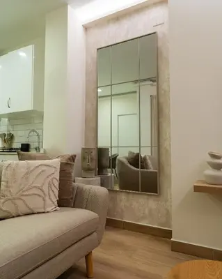 a living room with a couch and a mirror at Viva Valencia Apartments - Arte & Reflejos in Valencia