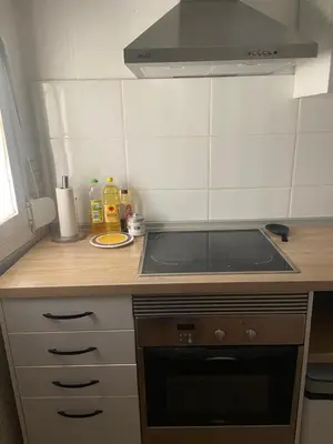 a kitchen with a stove and a counter top at Clau al castell apartament in Serra