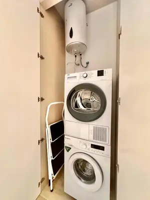 a laundry room with a washer and dryer at Joaquin Costa Urban Flat in Valencia