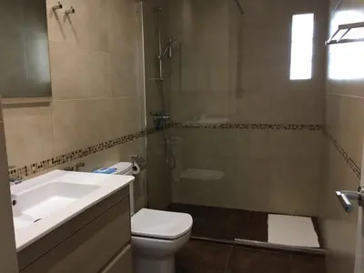 a bathroom with a sink and a toilet and a shower at Casa Cosy 2 in Valencia