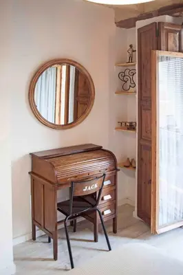 a wooden desk with a mirror and a chair at Apartment next to the beach in Valencia