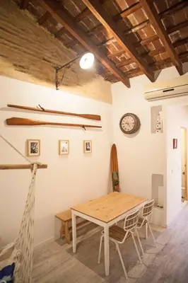 a dining room with a table and a clock on the wall at Apartment next to the beach in Valencia