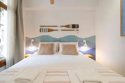 a bedroom with a large white bed with two pillows at Cabanyal Rooms by VLC Host in Valencia