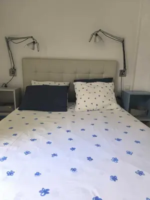 a bedroom with a bed with blue flowers on it at Encantador Loft Cabañal · Playa Las Arenas in Valencia