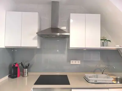 a kitchen with white cabinets and a sink at Encantador Loft Cabañal · Playa Las Arenas in Valencia