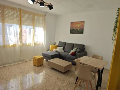a living room with a couch and a table at SeaSuites Yellow - Loft cerca del mar en Cullera in Mareny de San Lorenzo