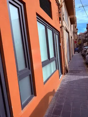 an orange building with windows on a street at Loft acogedor y luminoso in Valencia