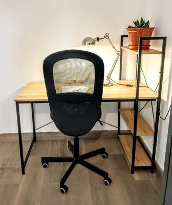 a black office chair sitting at a desk at Casa Yaiza in Valencia