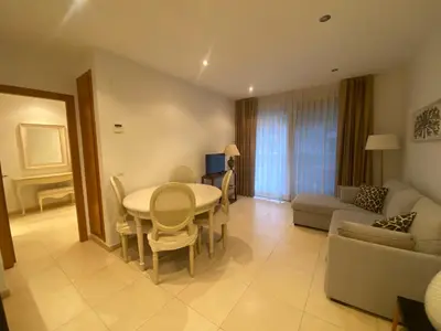 a living room with a table and a couch at Apartamento en primera línea de playa 38 in Valencia