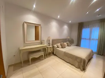 a bedroom with a bed and a desk and a mirror at Apartamento en primera línea de playa 38 in Valencia