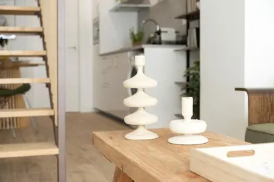 two white candles sitting on top of a wooden table at Loft Valencia M11 - Ground & Arena Connected in Valencia