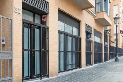 a brick building with black doors on a street at Modern & Stylish Apartment Close to the Beach in Valencia