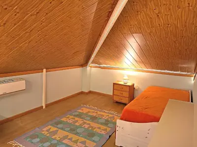 a small bedroom with a bed and a night stand at La Villa Blanca in Pedralba