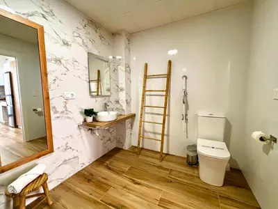 a bathroom with a toilet and a mirror at Travel Habitat Santo Domingo Loft in Valencia