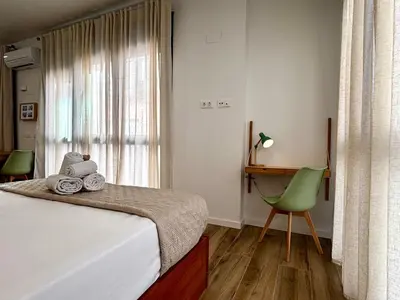a bedroom with a bed and a desk and a chair at Travel Habitat Santo Domingo Loft in Valencia